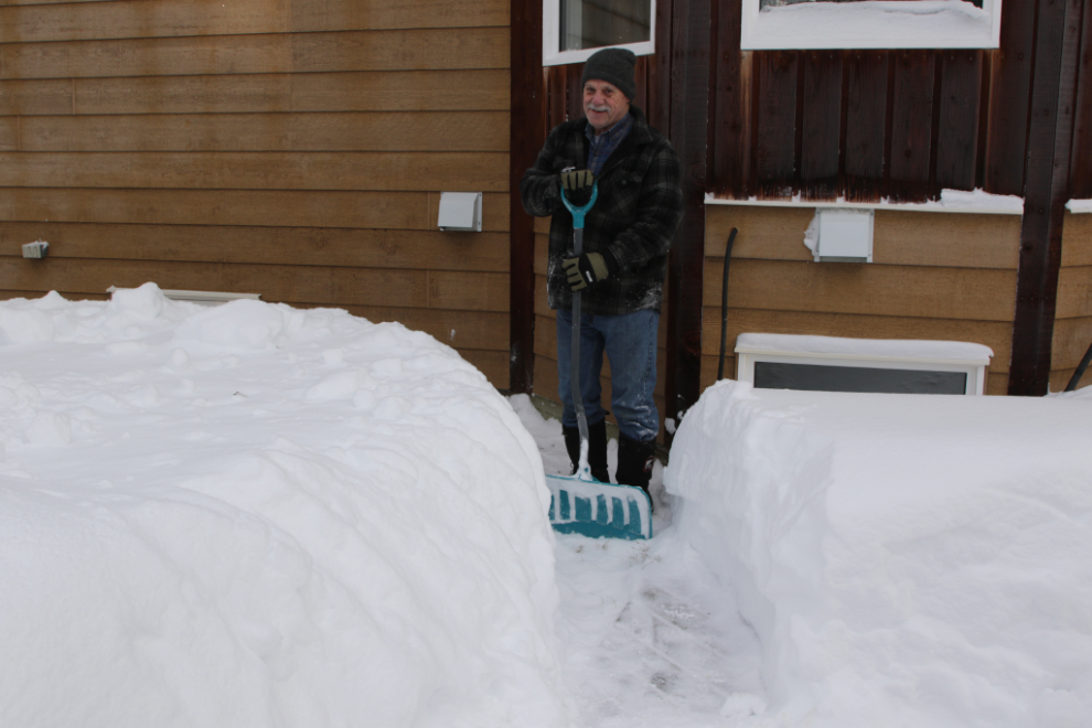 Digging a path through deep snow to the bird feeder.