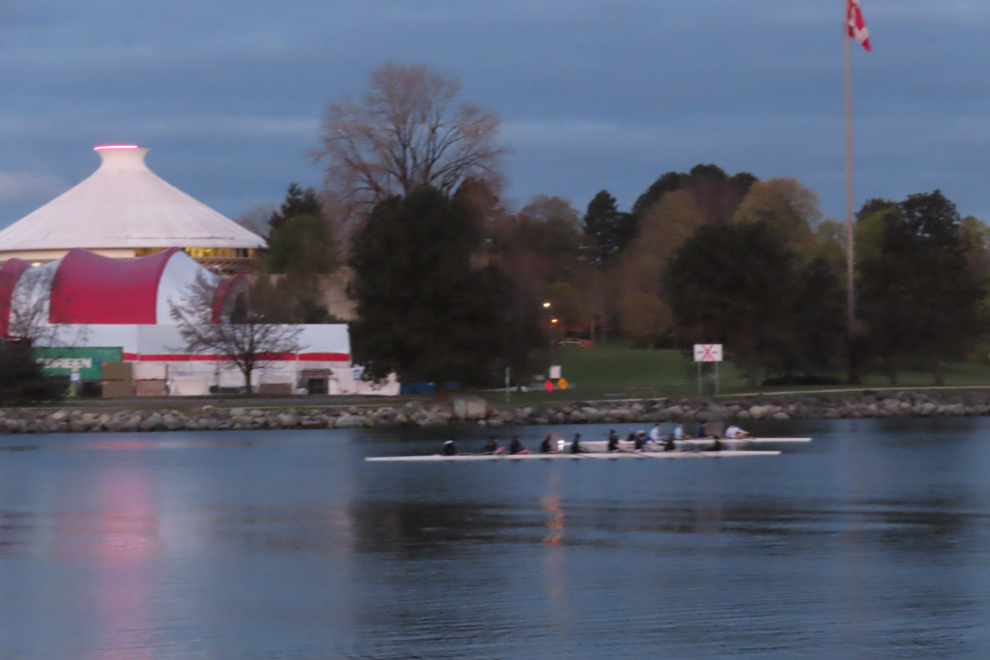Two boats full of rowers at False Creek , Vancouver- hard at it at 05:40.