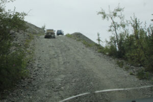 SUVs climbing a steep hill to the Whitehorse Copper Belt.